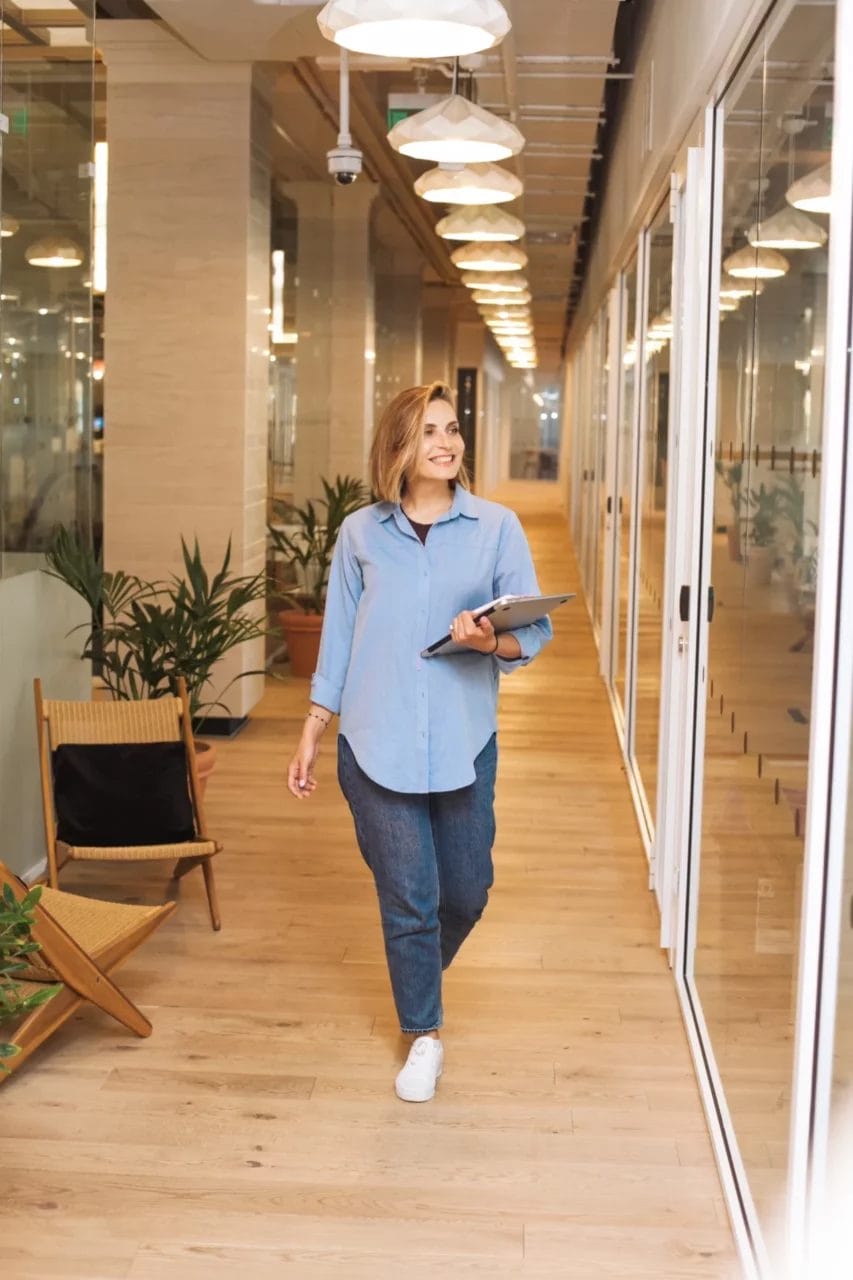 woman walking happily to a meeting room